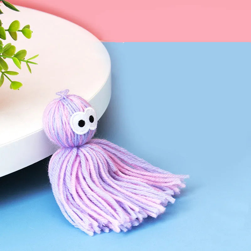 Bite-resistant wool cat ball toy with hanging attachment in blue grey, pink and blue, or pink purple colours