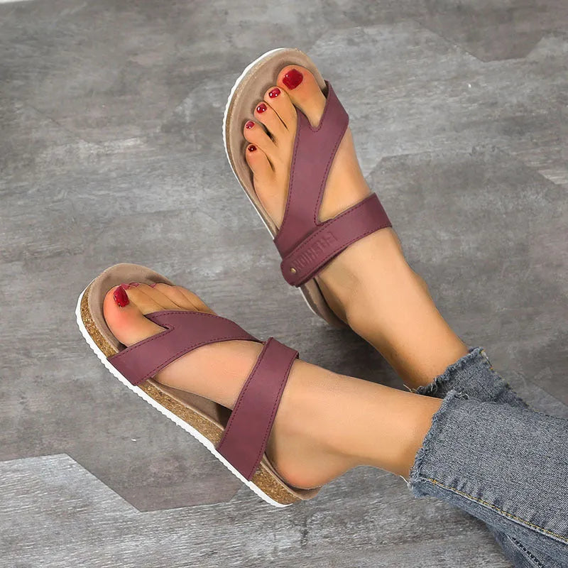 Flat toe ring thick-soled flip-flops in a solid colour on a light background