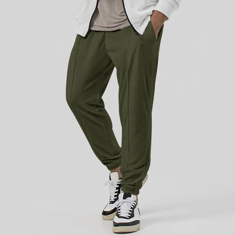 Men's grey casual track sweatpants with loose tapered cut and straight leg design, elastic waistband