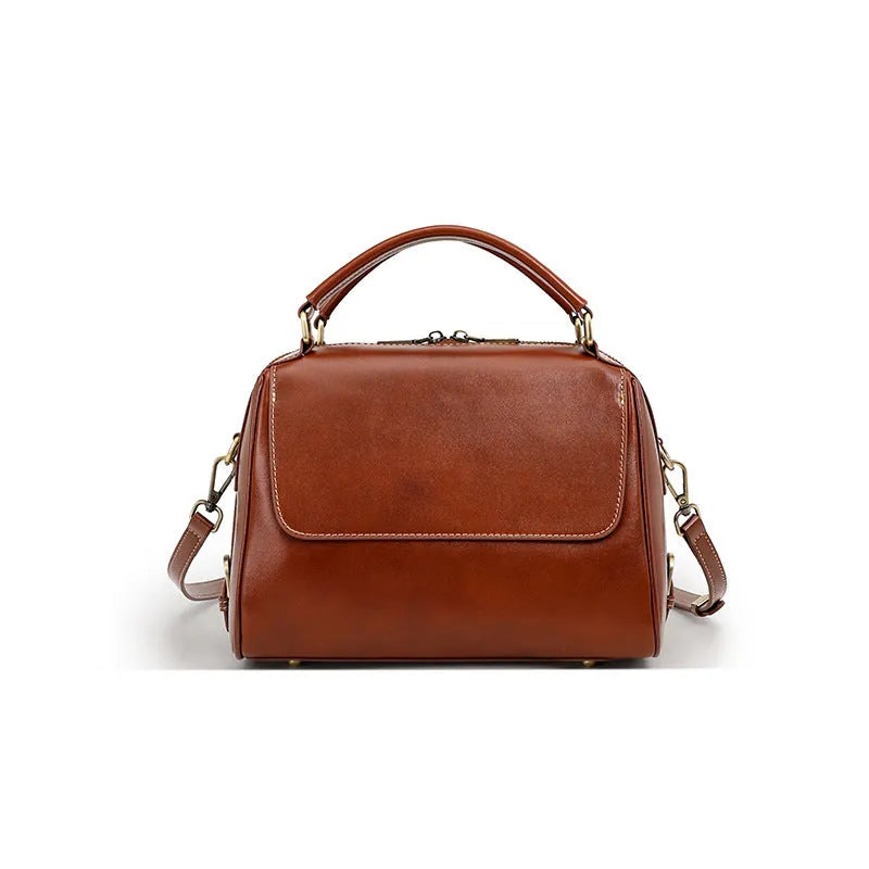 Women's genuine leather crossbody tote bag in apricot colour showing internal compartments and shoulder straps.