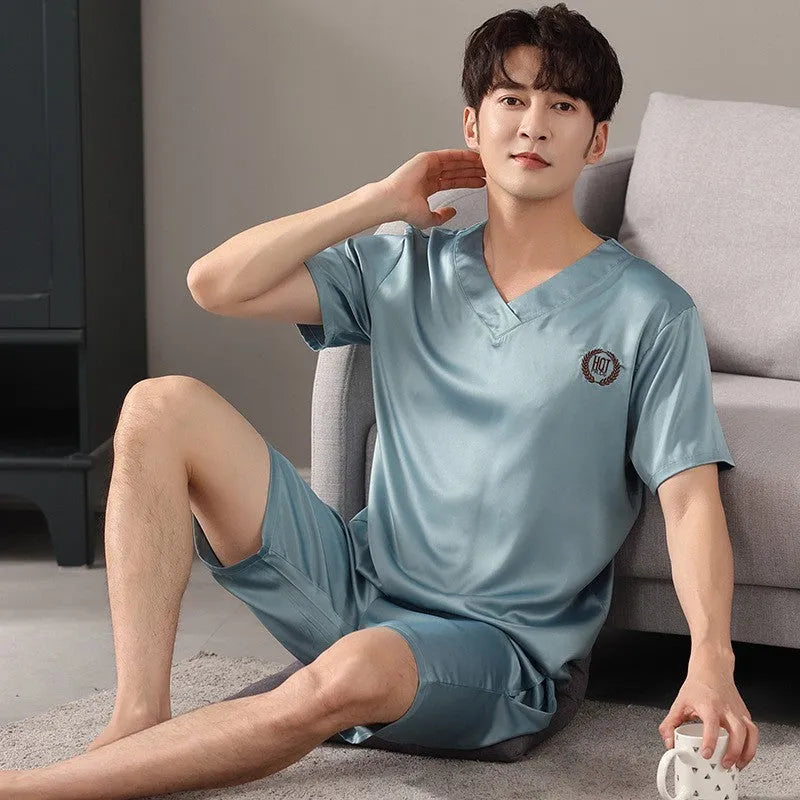 Man's ice silk short-sleeve pyjama shirt and shorts set in a loose, comfortable fit on a hanger