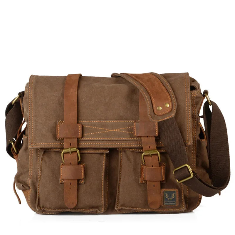 Men's brown retro canvas crossbody shoulder bag with cowhide trim, shown with flap open revealing internal zip pockets.