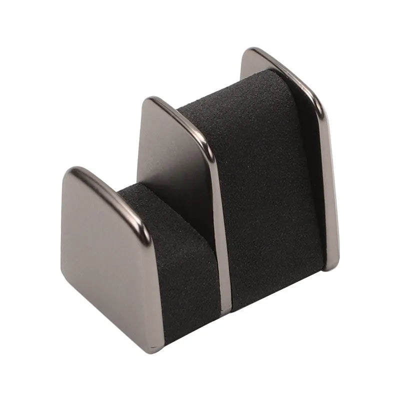 Green zinc alloy and leather glasses clip holder mounted on a car dashboard.
