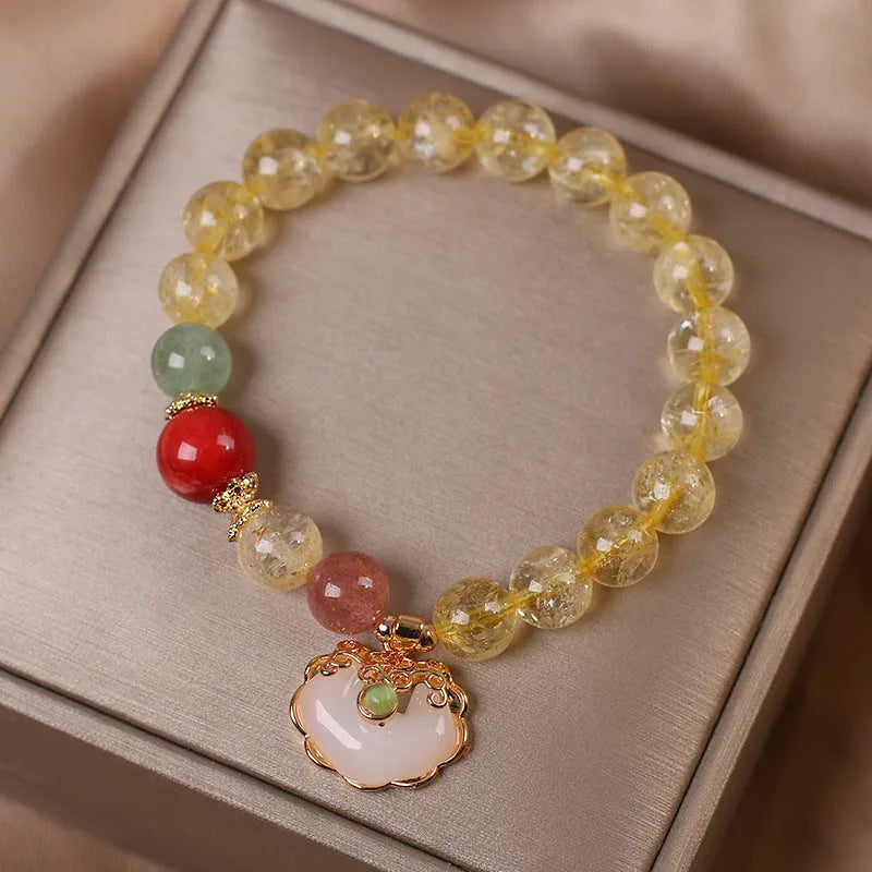 Women's yellow hair crystal jade Ruyi pendant on an alloy bracelet.