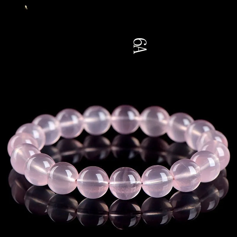 Women's natural style bracelet with round polished crystal beads in pink, showing size options from small to large beads.