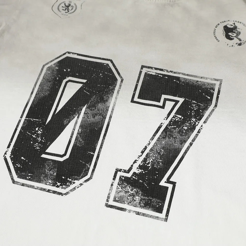 Men's black and white printed short-sleeved cotton T-shirt on a size chart.
