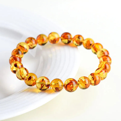 Natural yellow piebald amber bracelet with geometric design and polished Baltic amber beads