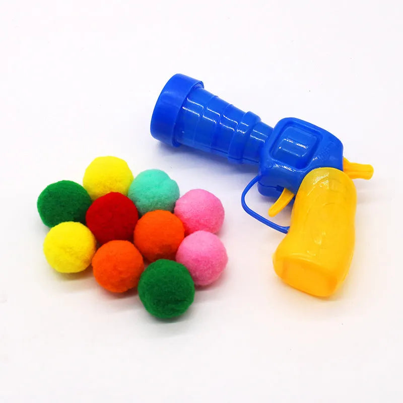 Pet toy launcher gun with assortment of soft plush balls for dog fetching games