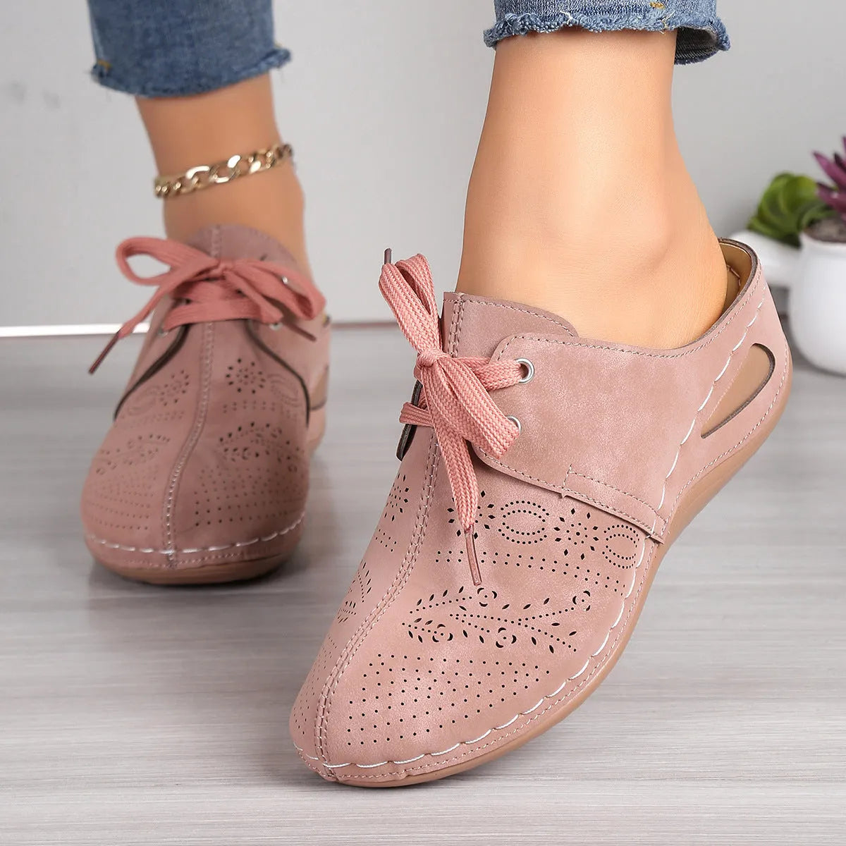 Women's black suede lace-up wedge slippers with a baotou toe and hollow out heel on a rubber sole.