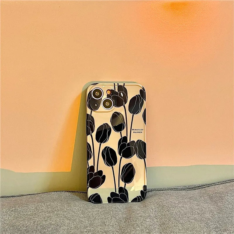Black silicone phone case with a tulip floral pattern for iPhone.