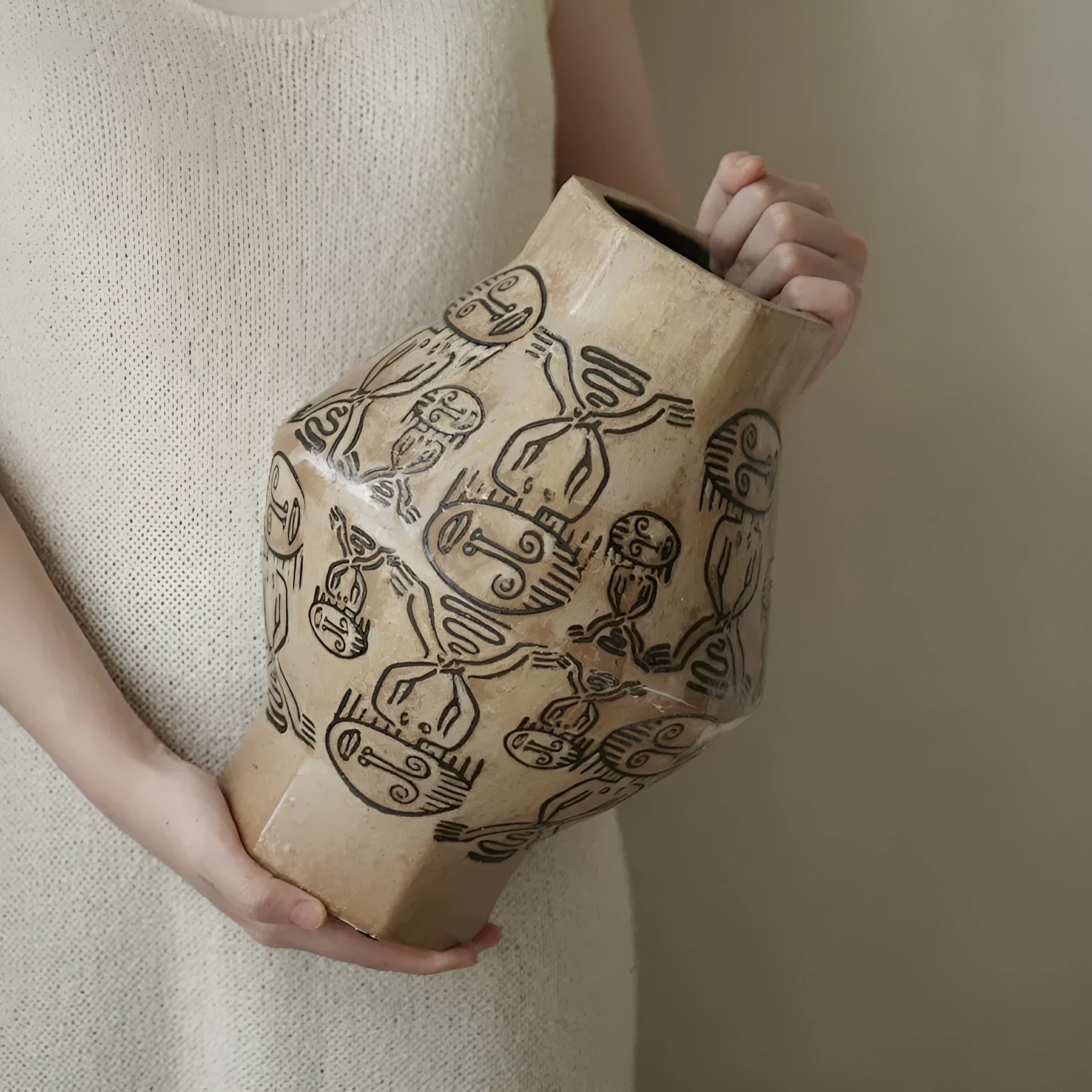 Hand-painted ceramic vase with vintage carved religious patterns in cylindrical shape