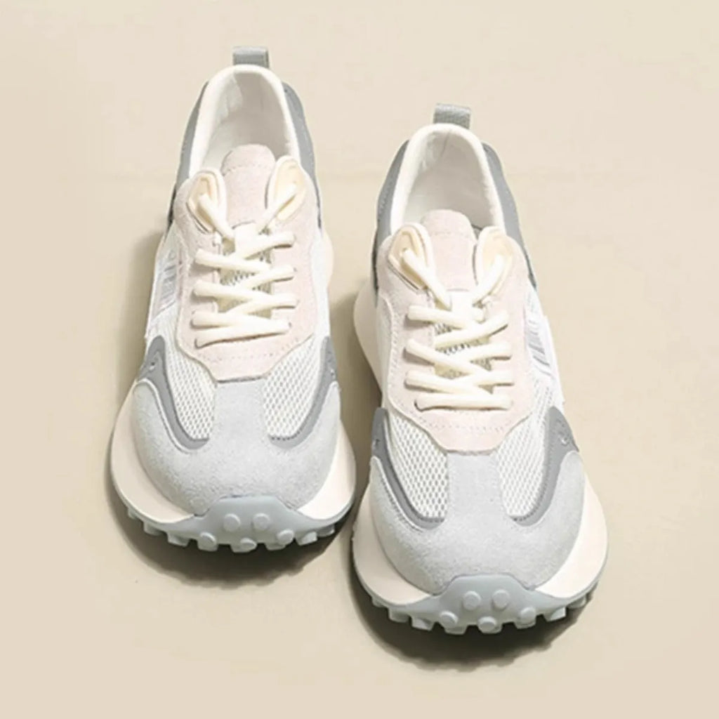 Women's grey retro sneaker with low-top design, mesh lining, and rubber sole