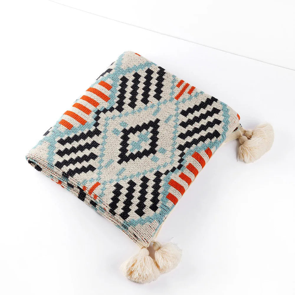 Bohemian-style acrylic sofa blanket with tassel edges in geometric pattern or solid colour options