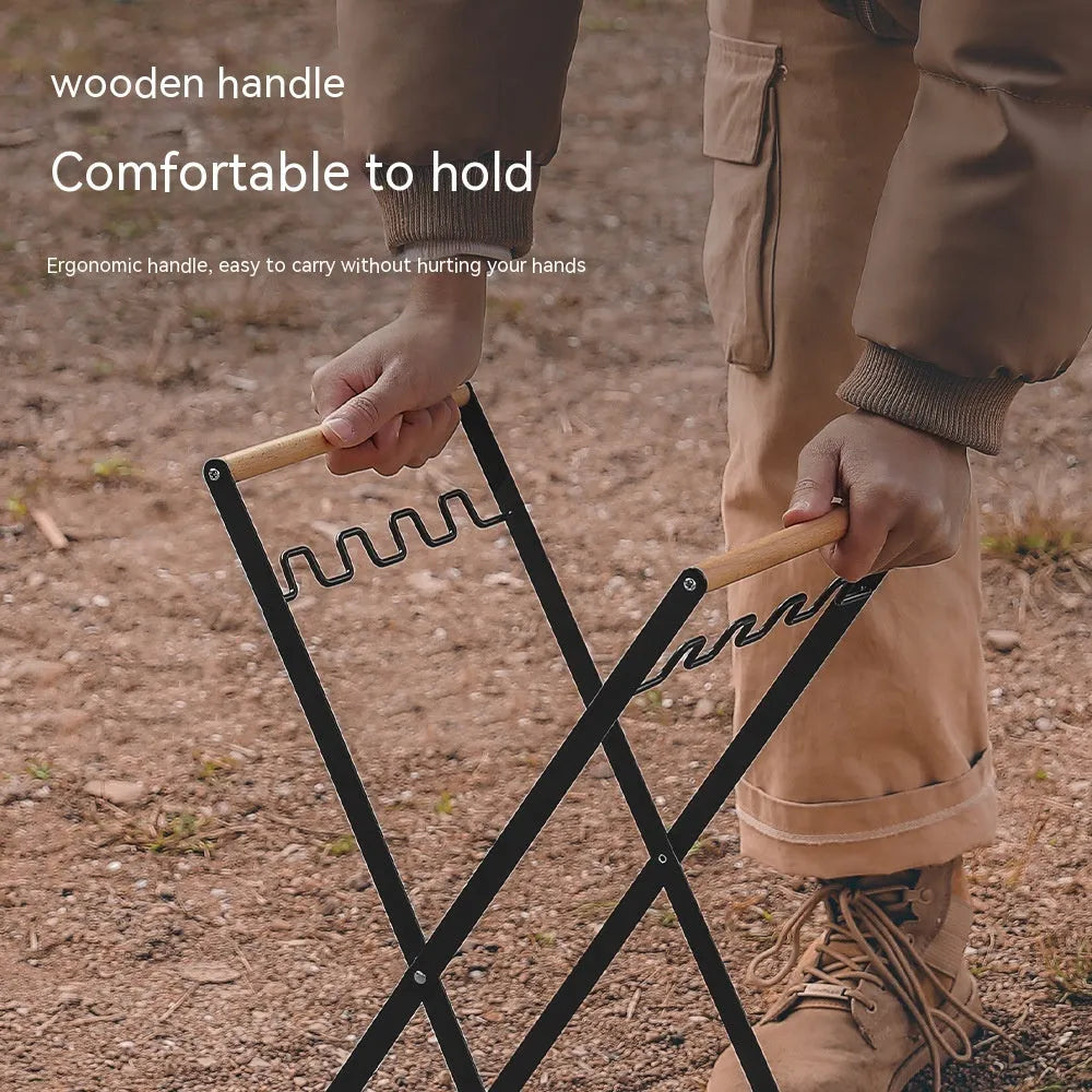 Black folding iron trash rack with wooden handles holding a bin bag outdoors