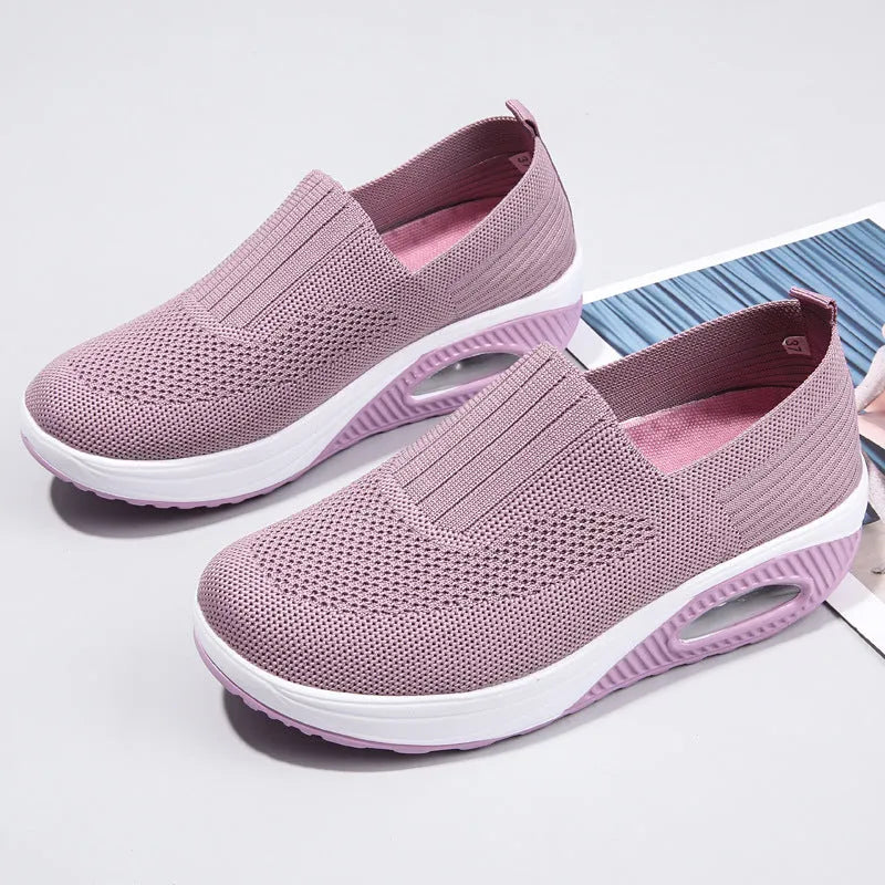 Women's mesh running shoes with air cushion midsole in beige colour on a white background.