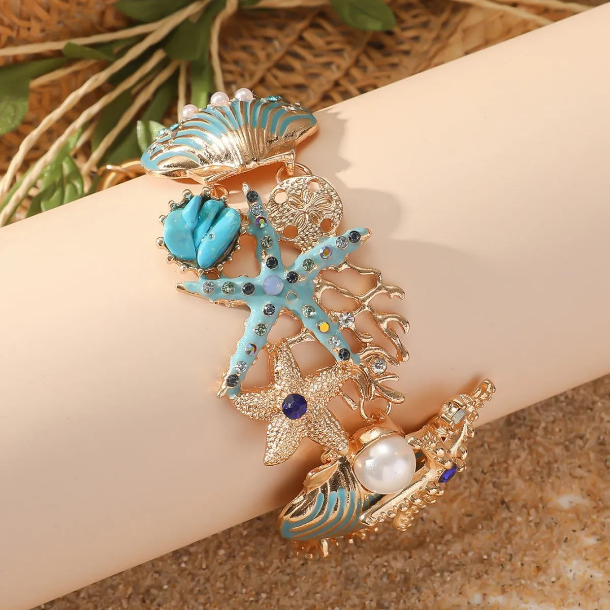 Alloy marine shell boat anchor rhinestone bracelet with starfish details in turquoise colour.