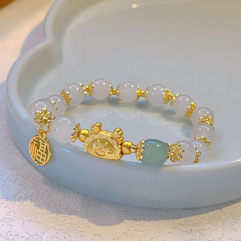 Glass floral glazed bracelet with zodiac animal charm in red, pink, and white pearl bead colours