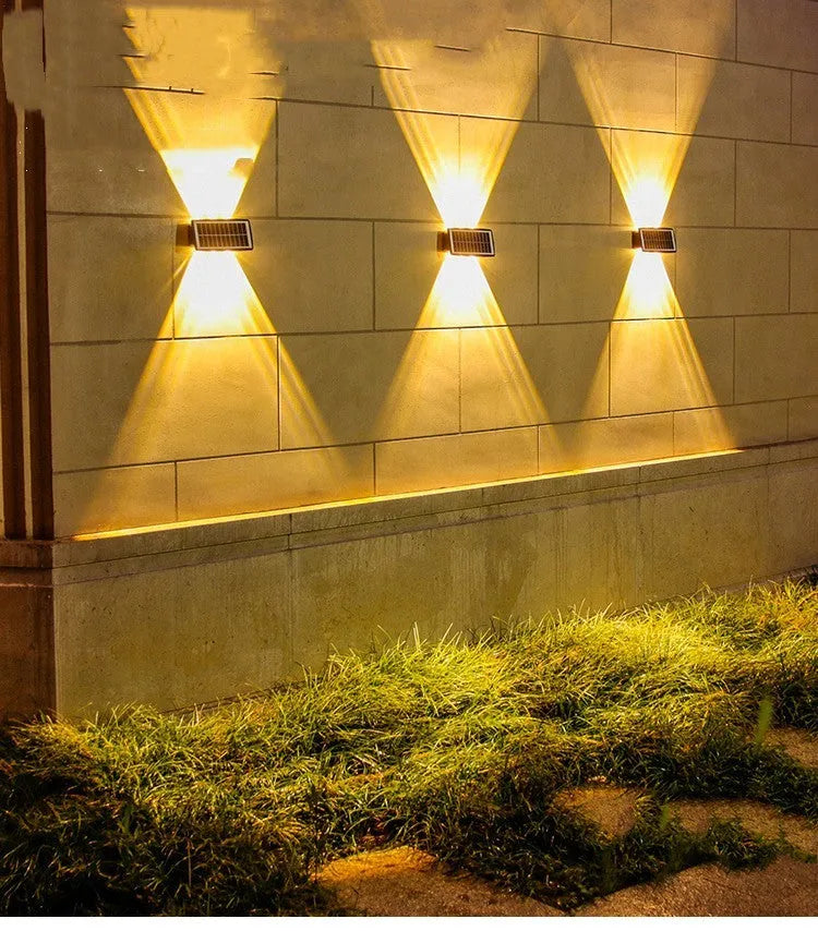 Solar outdoor wall light with 4 LED beads, ABS+PC housing, and glass polysilicon solar panel mounted on a brick wall