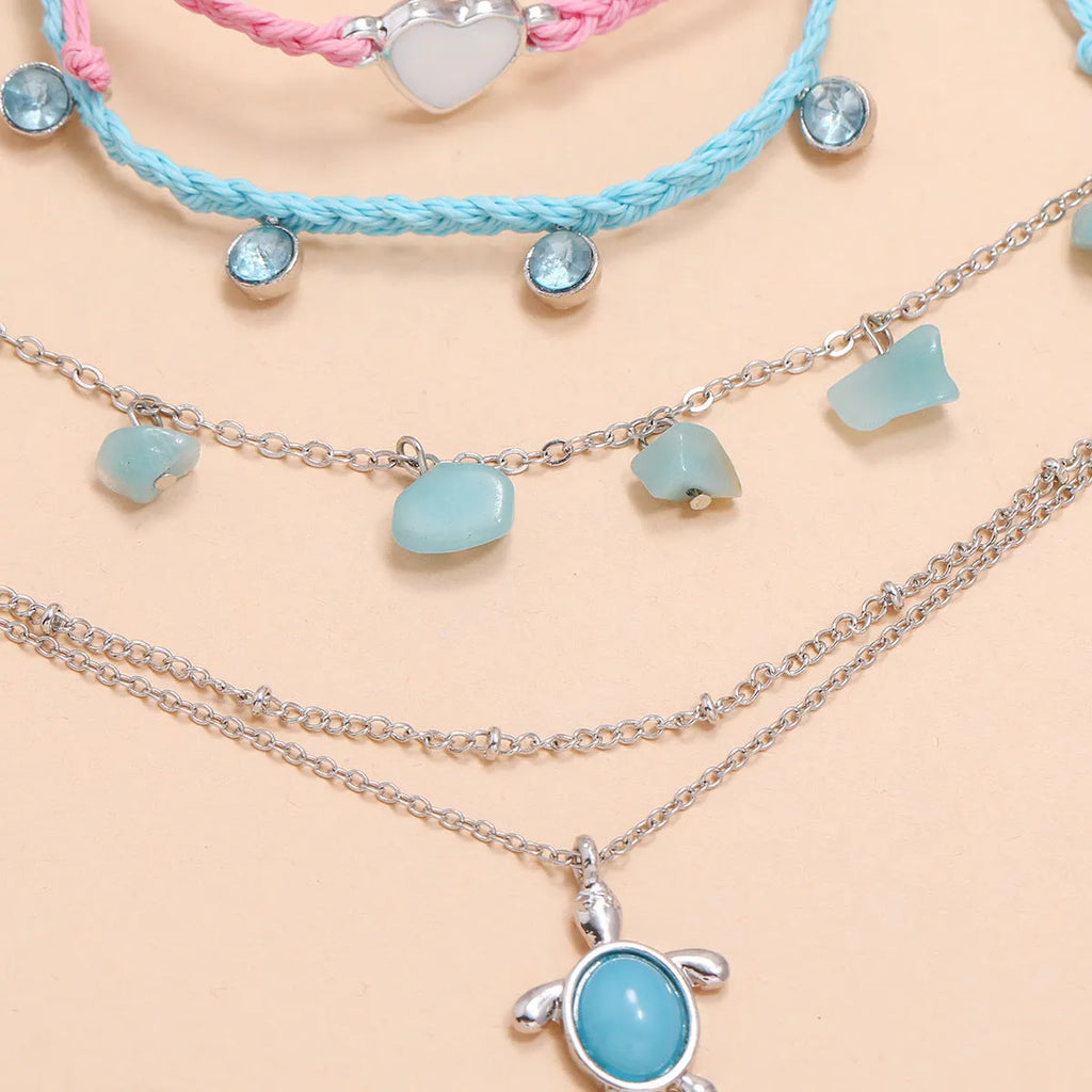 Hand-woven blue love foot rope natural gravel anklet in alloy with geometric shape on a woman's ankle