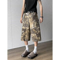 Women's yellow snake camouflage print cropped jeans on a model.