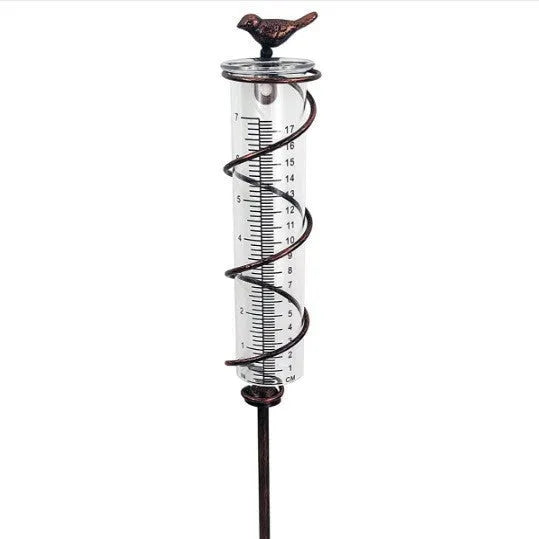 Cast iron garden hyetometer with glass rain gauge showing hummingbird design and measurement scale