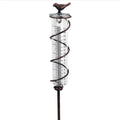 Cast iron garden hyetometer with glass rain gauge showing hummingbird design and measurement scale