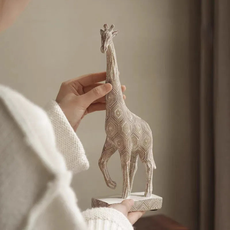 30.5cm tall synthetic resin giraffe ornament in wood colour standing on a shelf