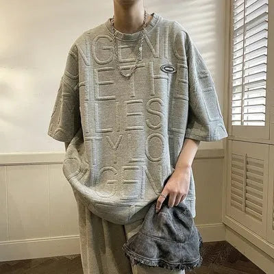 Men's grey t-shirt with raised three-dimensional letter pattern on chest, short sleeve loose fit