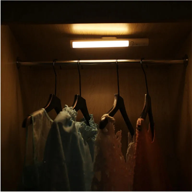 Slim white human body induction LED cabinet light with magnetic strip on back for mounting