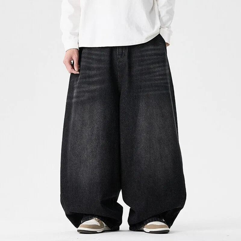 Men's plus size light blue wide leg baggy jeans on a neutral background