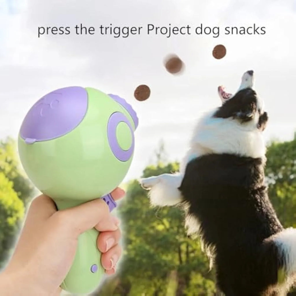 Green, orange, and pink ABS plastic dog treat launcher toy on a white background.