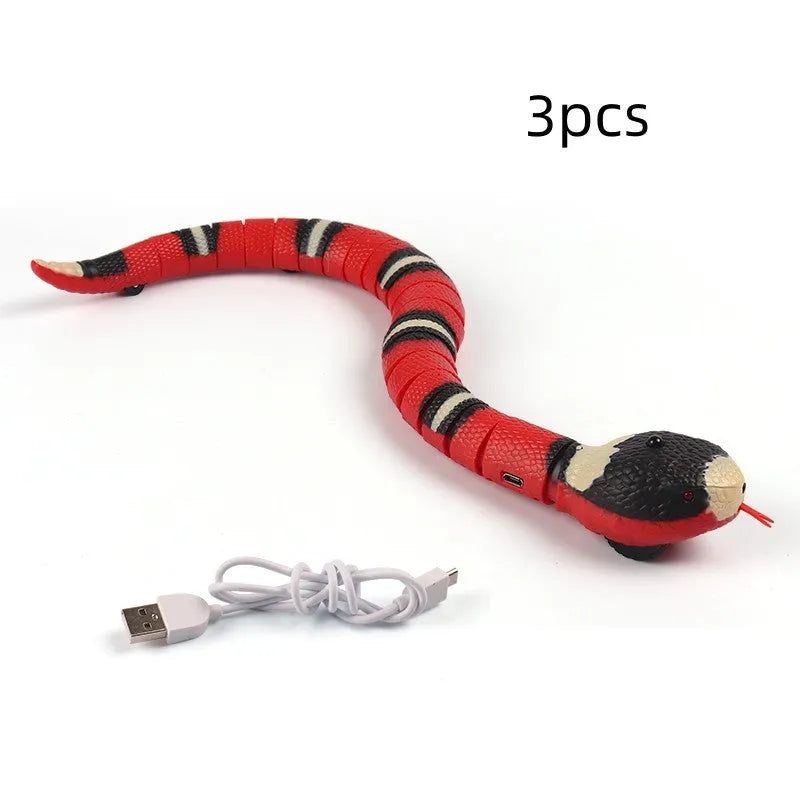 Smart sensing electronic snake cat toy with segmented plastic body and USB charging cable.