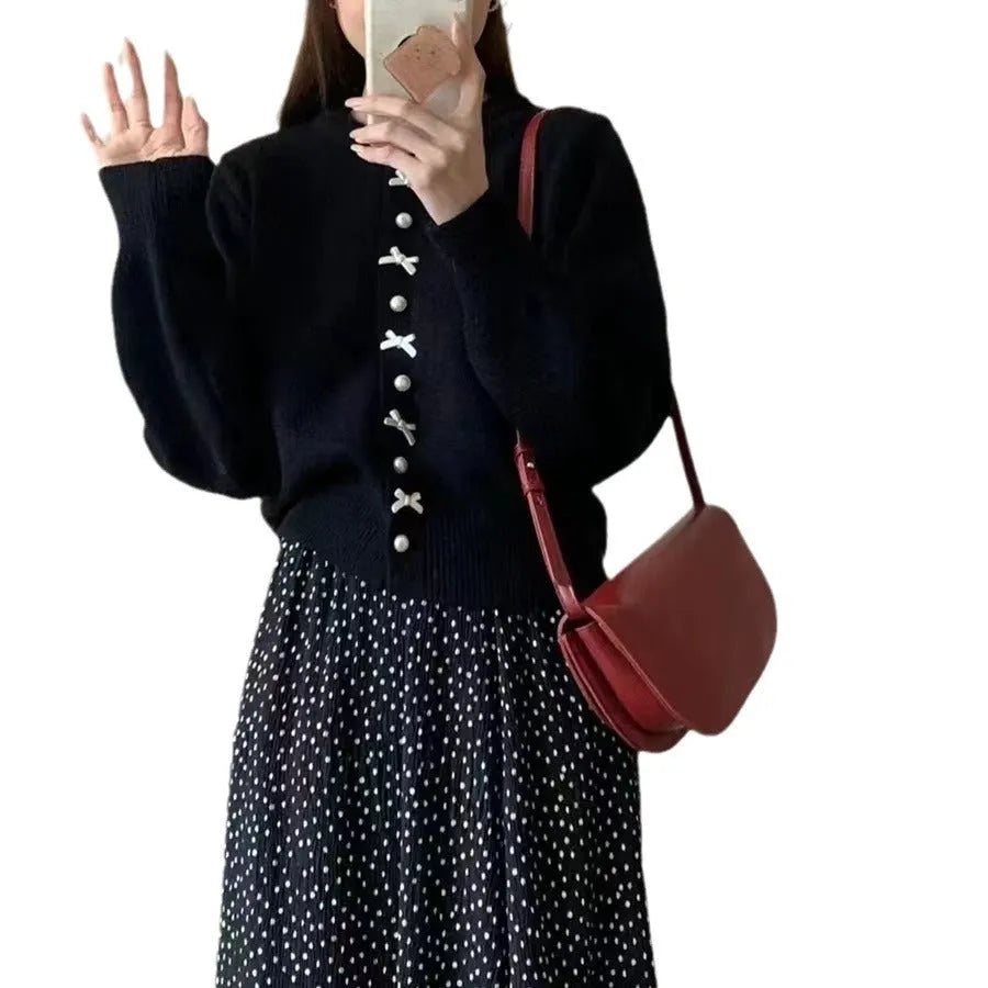 Women's solid colour cardigan sweater with pearl buttons in a light blue shade, shown open.
