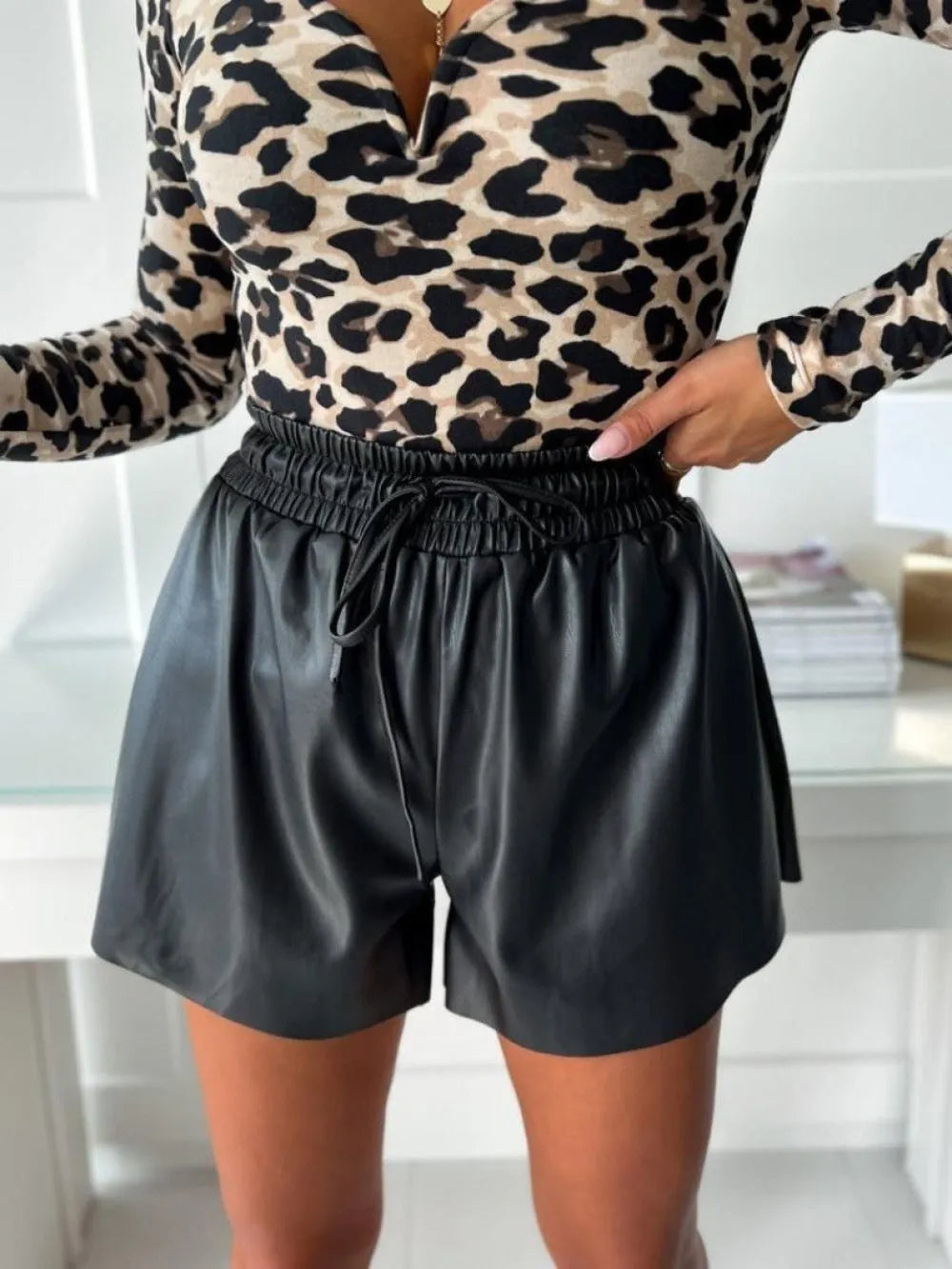 Women's black wide-leg casual shorts with a drawstring lace PU leather front detail.