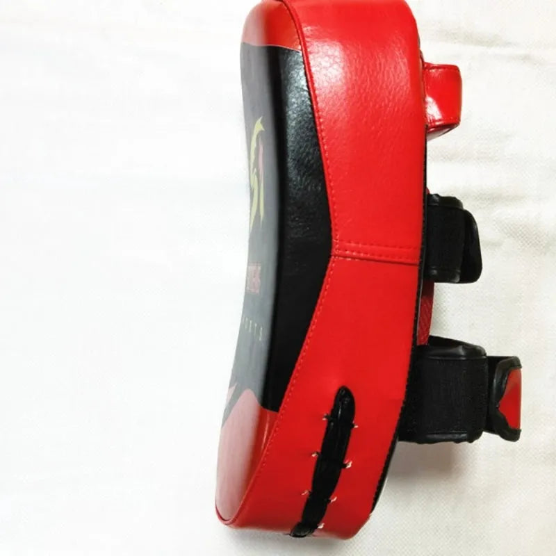Black square boxing target pad with red trim and a double buckle strap on the back