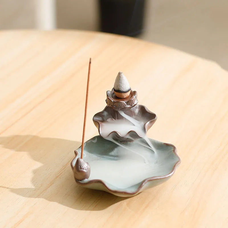 Square purple clay ceramic reverse flow incense burner with lotus and plum blossom decoration.