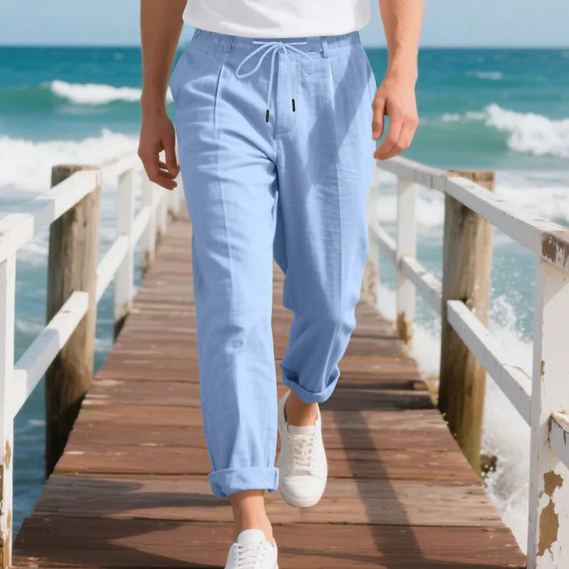 Men's loose-fit straight-leg linen trousers in light khaki colour with a drawstring waist.