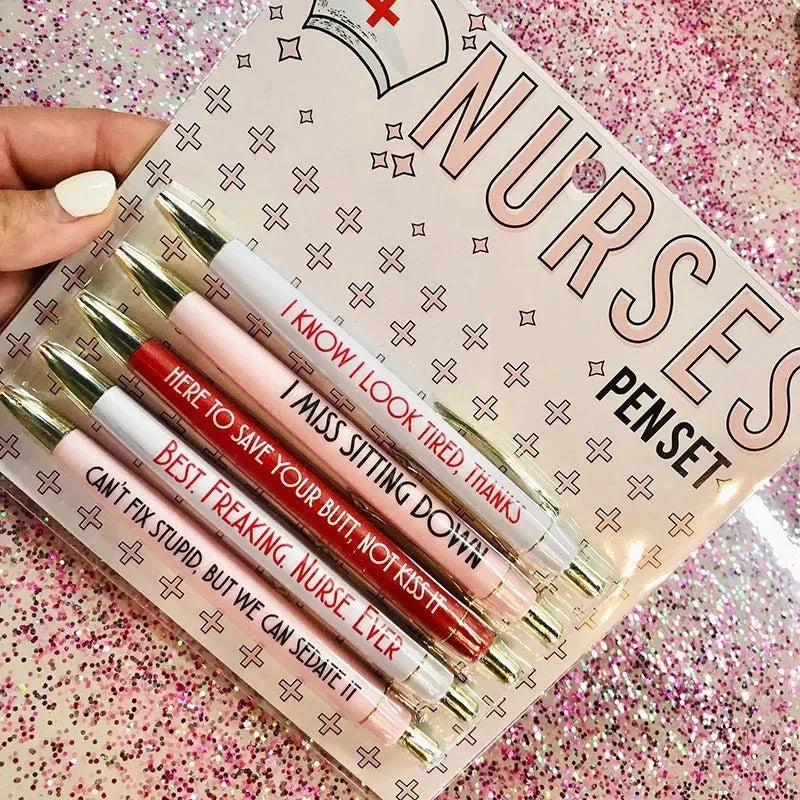 Five nurse-themed retractable ballpoint pens laid out, showing humorous medical designs.