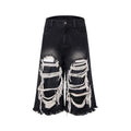 Black cropped wide-leg jeans with ripped patch detail on the leg, showing a mid-high waist and loose fit.