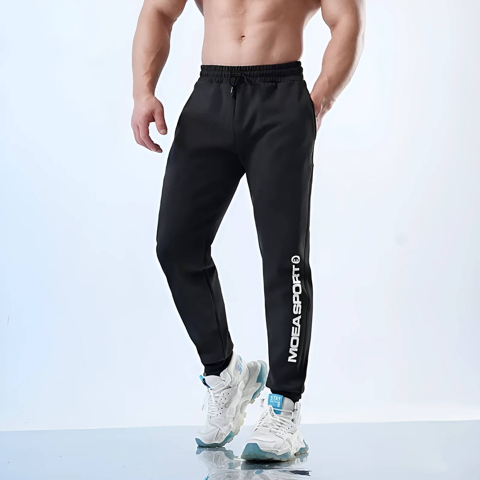Men's black ankle-tied sweatpants with mid-waist design and polyester-spandex fabric