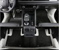 Custom black PU floor mats fitted in a Mitsubishi Outlander footwell.