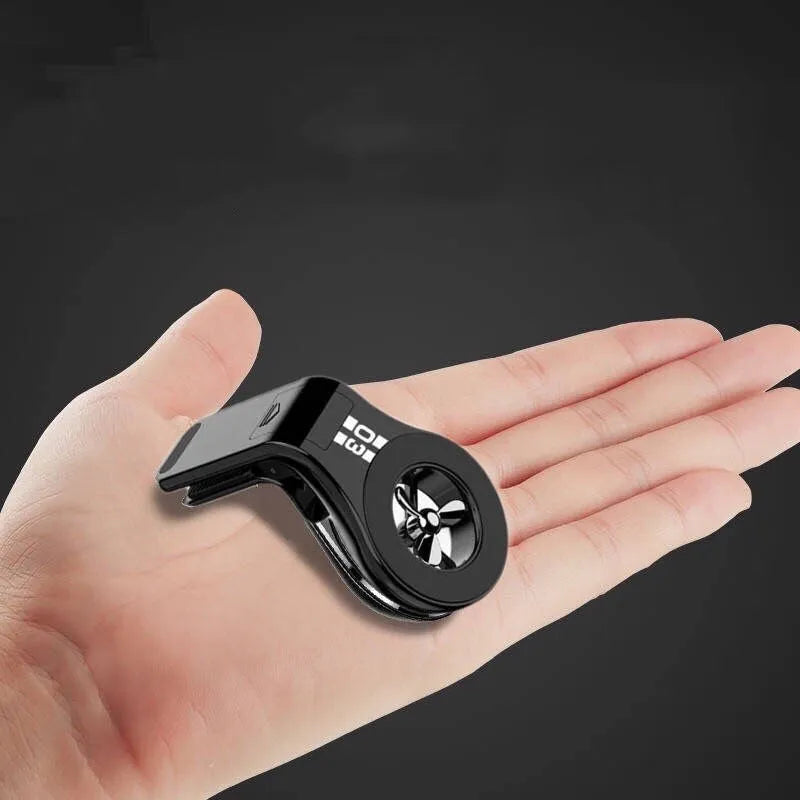 Magnetic car air vent phone holder with perfume dispenser in black, showing phone attached and fragrance slot.