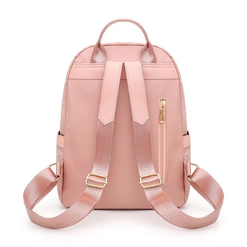 Black and pink casual nylon backpack with double straps, soft handle, and square vertical shape
