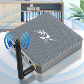 Android smart TV set-top box with voice remote control, HDMI cable, and power adapter on a table.