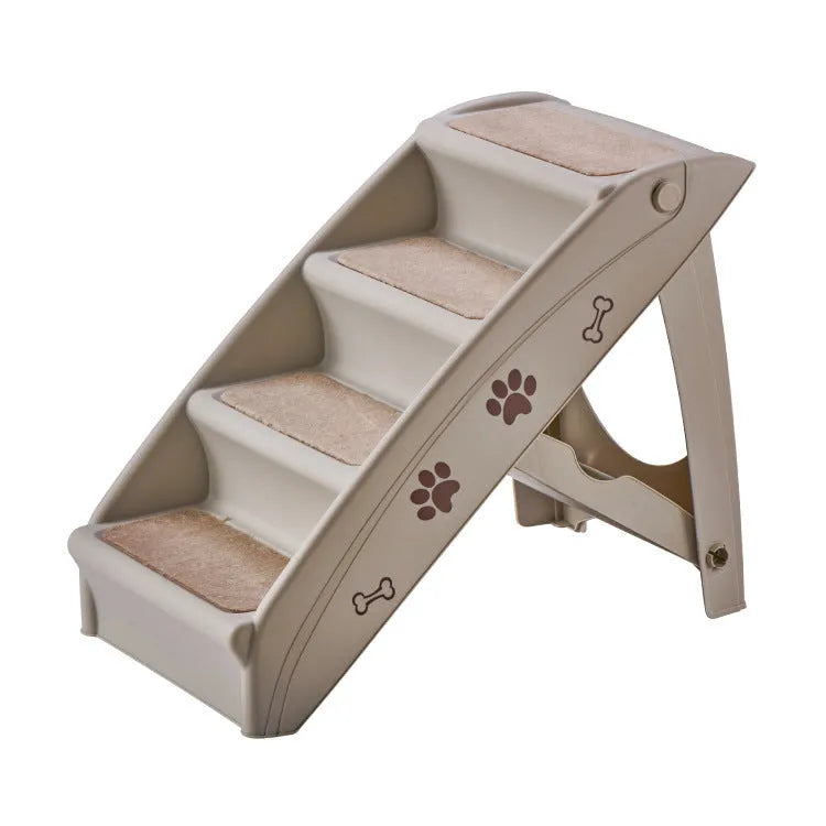 Foldable grey plastic pet stairs for small dogs and cats next to a sofa, with a non-slip mat visible.