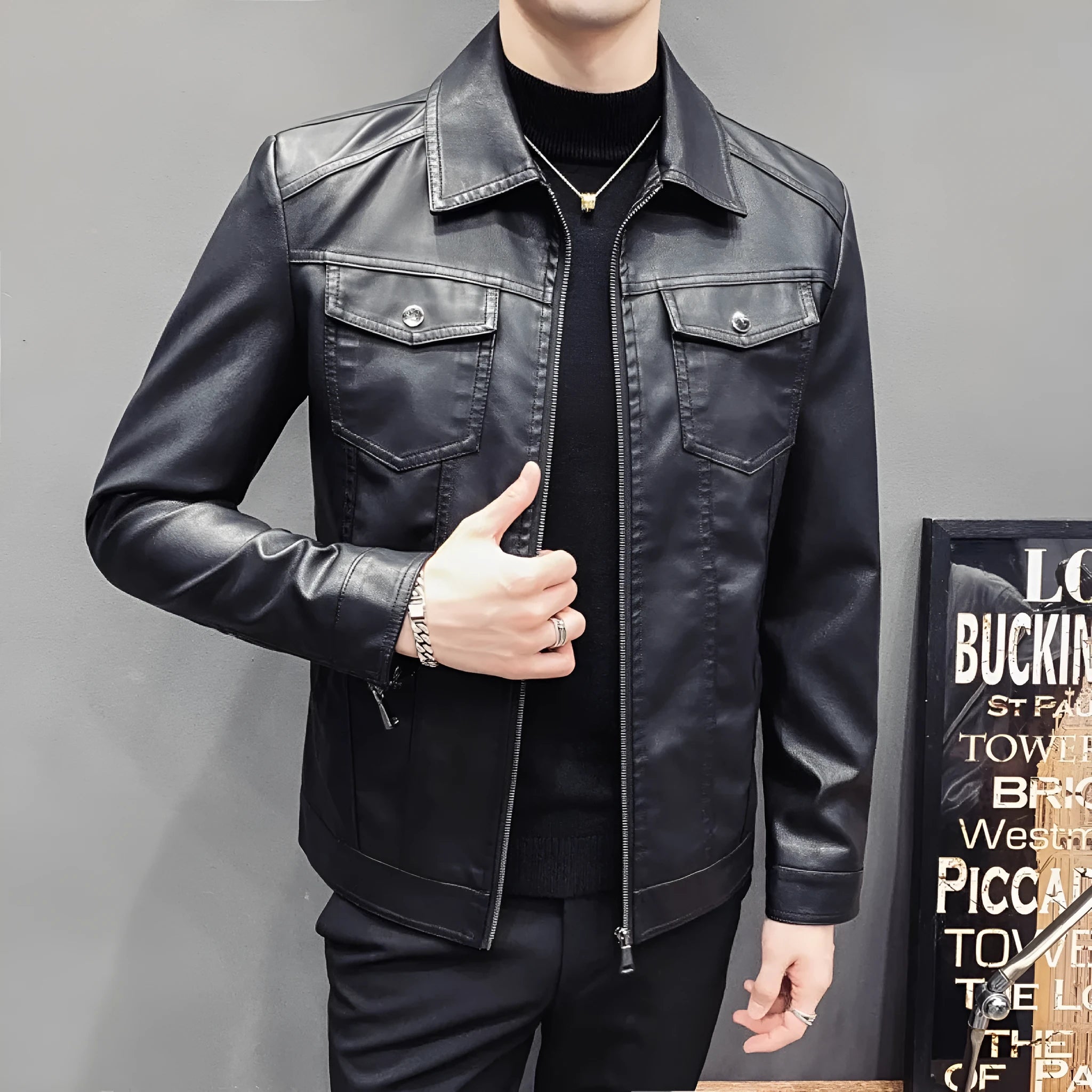 Men's quilted PU leather jacket with short length, side pockets, on a hanger