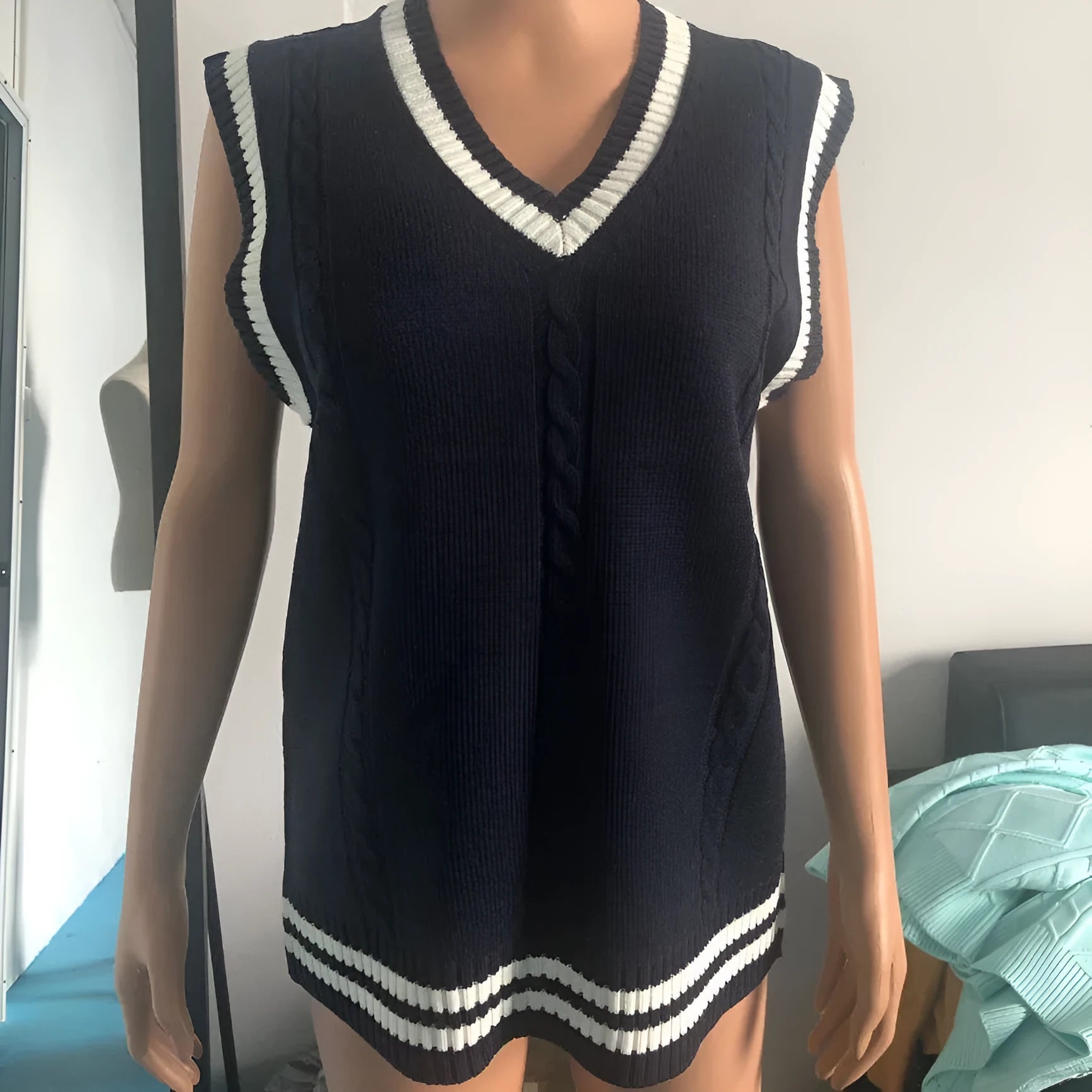 Women's slim fit V-neck knitted waistcoat sweater with striped stitching in acrylic fabric.