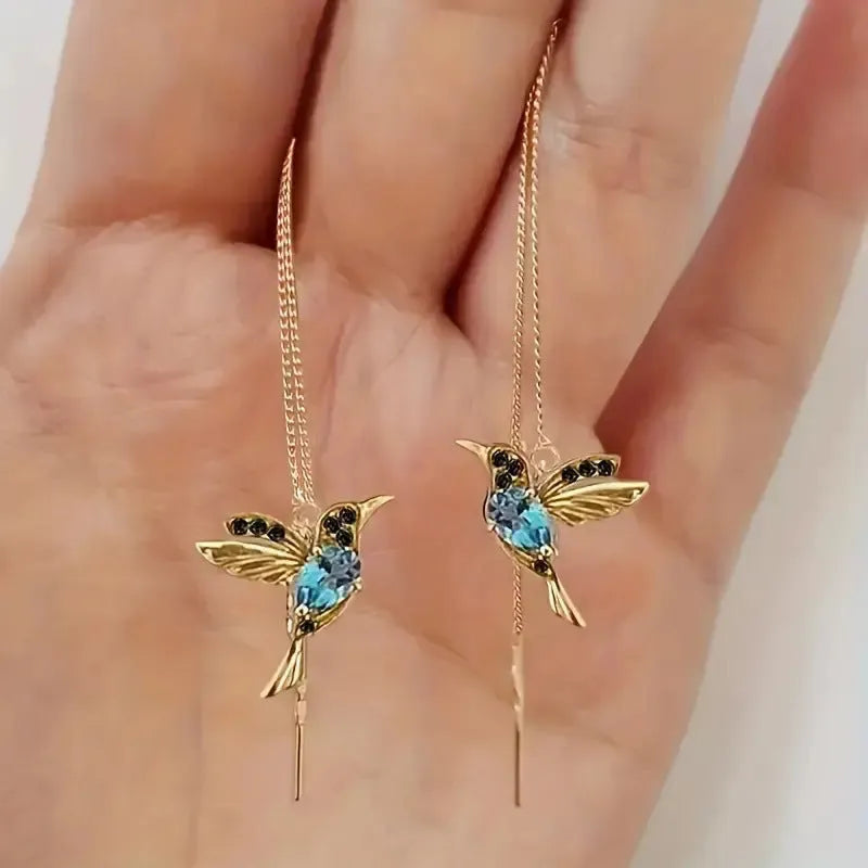 Long drop bird shaped alloy earrings for women with zirconium wings, shown in blue, red, and red lvzuan colour variations.