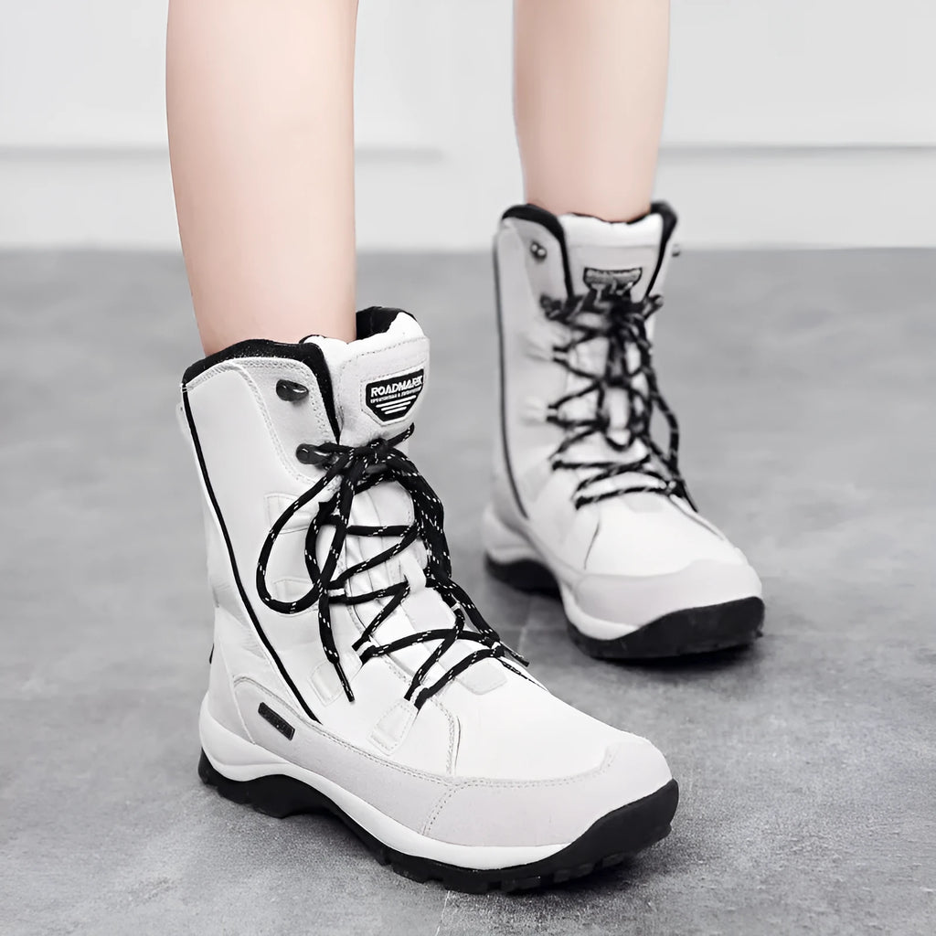 Women's mid-calf genuine leather snow boots in black with a round toe and rubber sole.