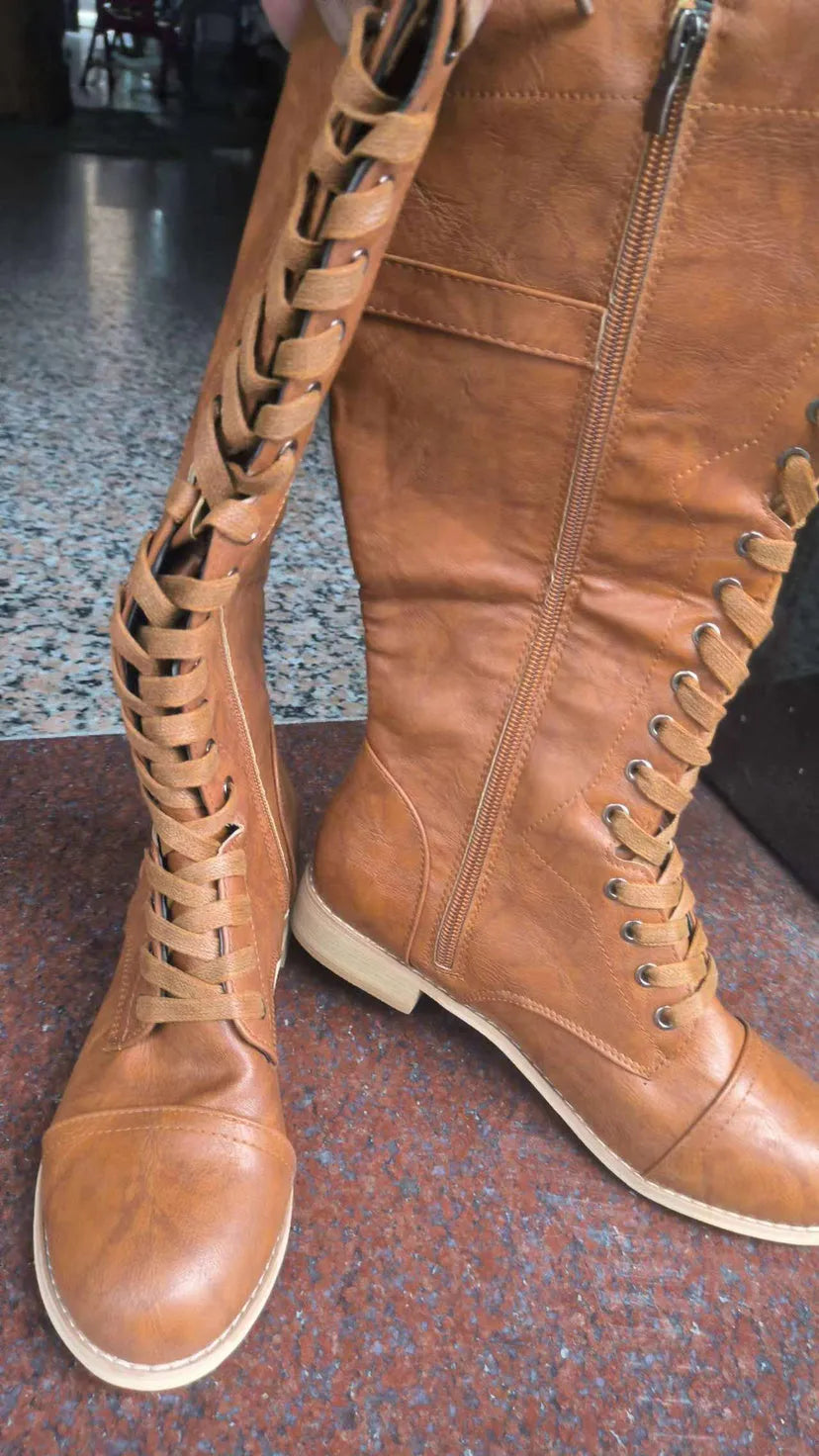 Women's black cross strap knight boots made from artificial PU.